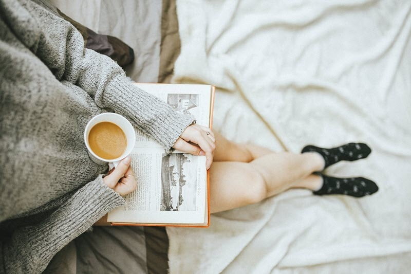 person relaxing with book